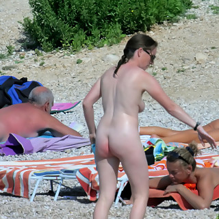 Watch naked girls sunbathing at naturist beaches with open legs so you can observe their pussies bet